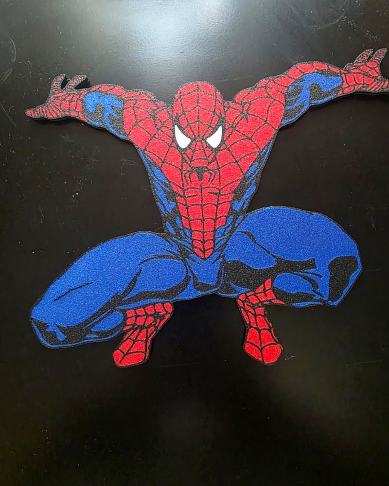 A red and blue Spider-Man wall-mount plaque in a crouching pose, with a sparkle finish.